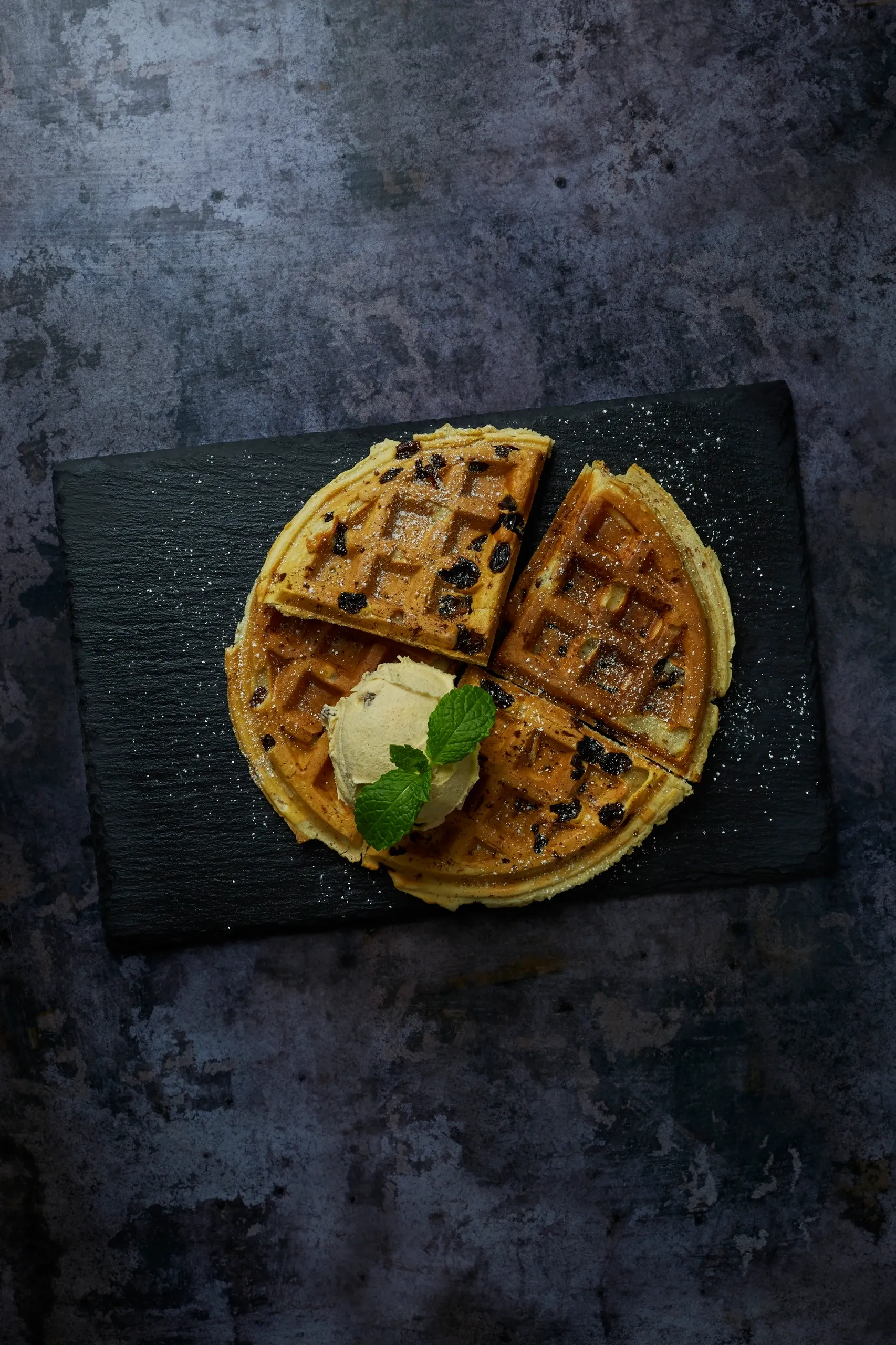 The Welsh Cake Waffle served whole with ice cream and mint on a slate board